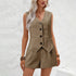 Woman wearing a beige vest and skirt set against a white textured wall.